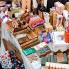 Handmade sustainable products displayed on a market stall, featuring soaps, eco-friendly packaging, and natural goods