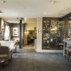 Cosy bar and bistro interior with plush seating, a well-stocked bar, and ambient lighting creating a welcoming atmosphere