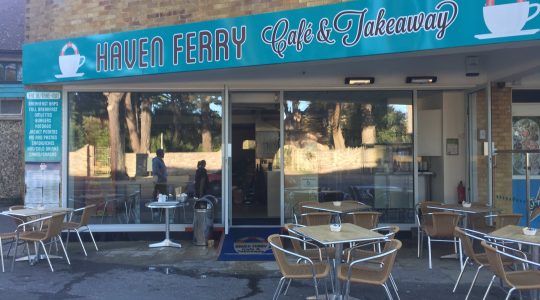 Haven Ferry Café & Takeaway with outdoor seating offering breakfast baps, sandwiches, and hot drinks in a cosy setting