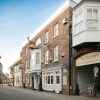 Street view of The Antelope pub, showcasing its historic brick facade and outdoor signage in a quaint neighbourhood