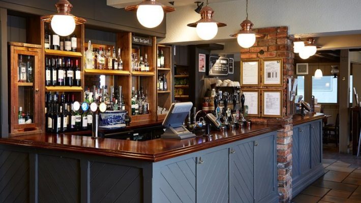 Street view of The Antelope pub, old brick building with bay windows and classic sign in a quiet area