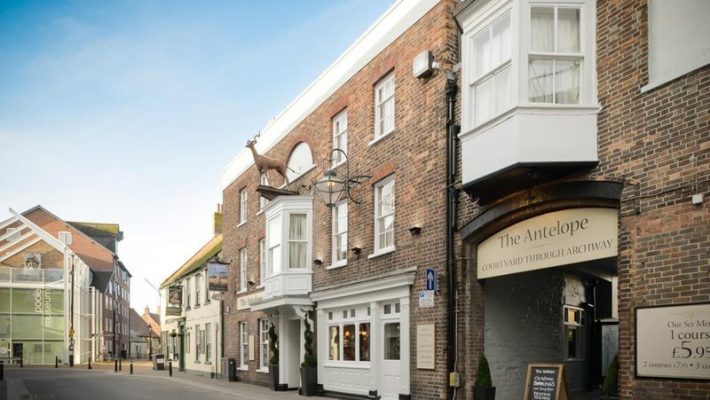 Street view of The Antelope pub, showcasing its historic brick facade and outdoor signage in a quaint neighbourhood