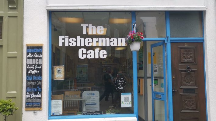 The Fisherman Cafe front entrance with menu board and open door, inviting customers in Bridlington
